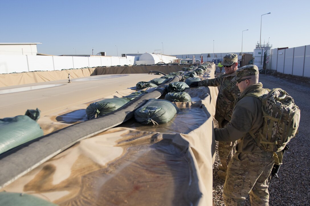 Brig. Gen. Robert D. Harter, deputy commanding general of the 1st Sustainment Command (Theater) / commanding general of the 316th Sustainment Command (Expeditionary), inspects fuel bags at Erbil, Iraq, on February 3, 2017. 