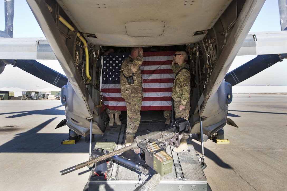 Brig. Gen. Robert D. Harter, deputy commanding general of the 1st Sustainment Command (Theater) / commanding general of the 316th Sustainment Command (Expeditionary), (left), reenlists Staff Sgt. Dalton Smith, public affairs noncommissioned officer in charge of the 1st TSC / 316th ESC, (right), on a MV-22 Osprey at Erbil, Iraq, on February 3, 2017. 