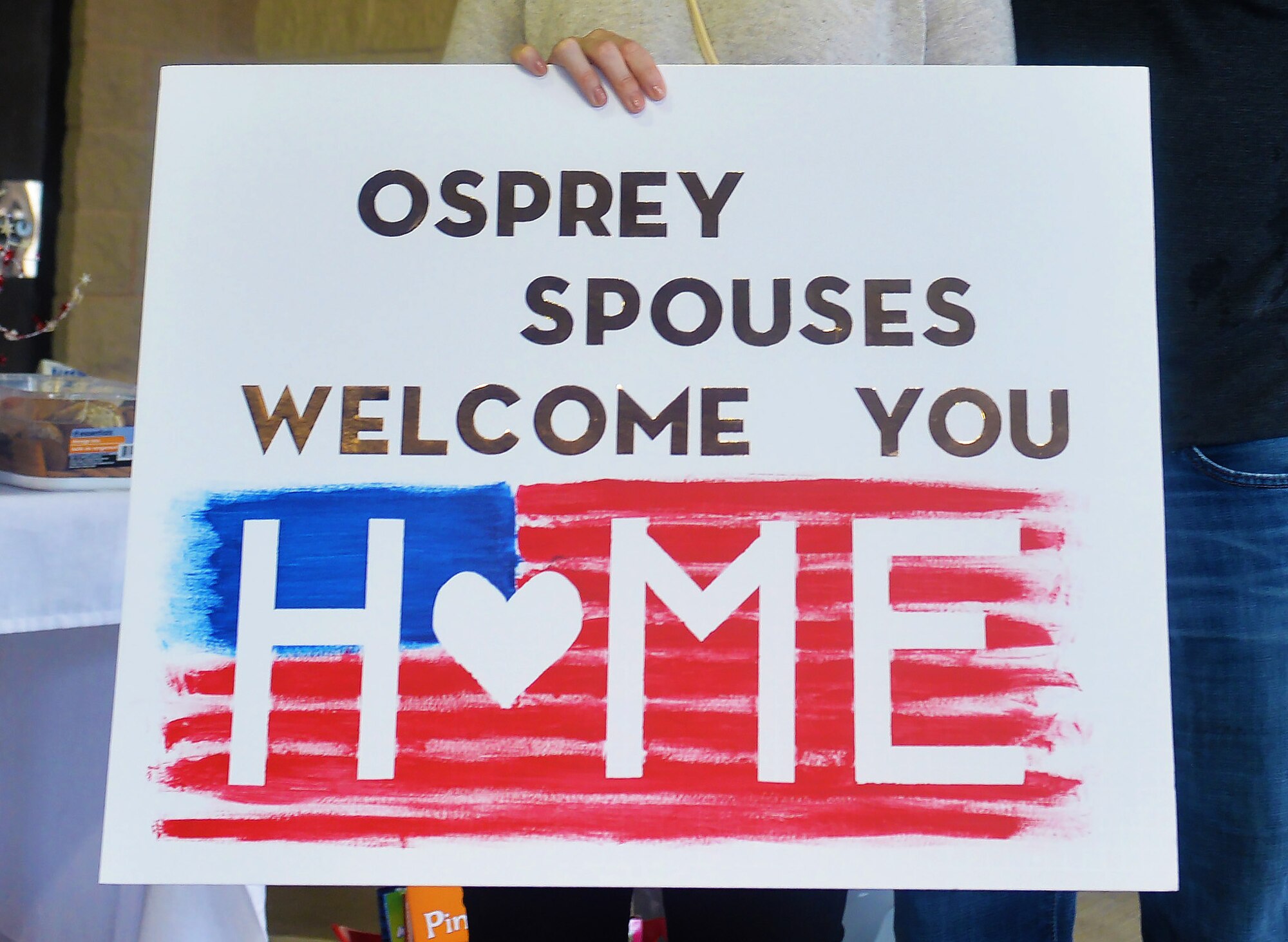 Kami Guevara, a key spouse program member with the 801st Aircraft Maintenance Squadron, greets Air Commandos returning from a deployment during an Operation Homecoming at Hurlburt Field, Fla., Feb. 7, 2017. Operation Homecoming is a program designed to allow families to welcome home Air Commandos after they return from deployments. The key spouse program is a formal unit program that offers informal peer-to-peer and wingman support to families within squadrons. (U.S. Air Force photo by Senior Airman Andrea Posey)