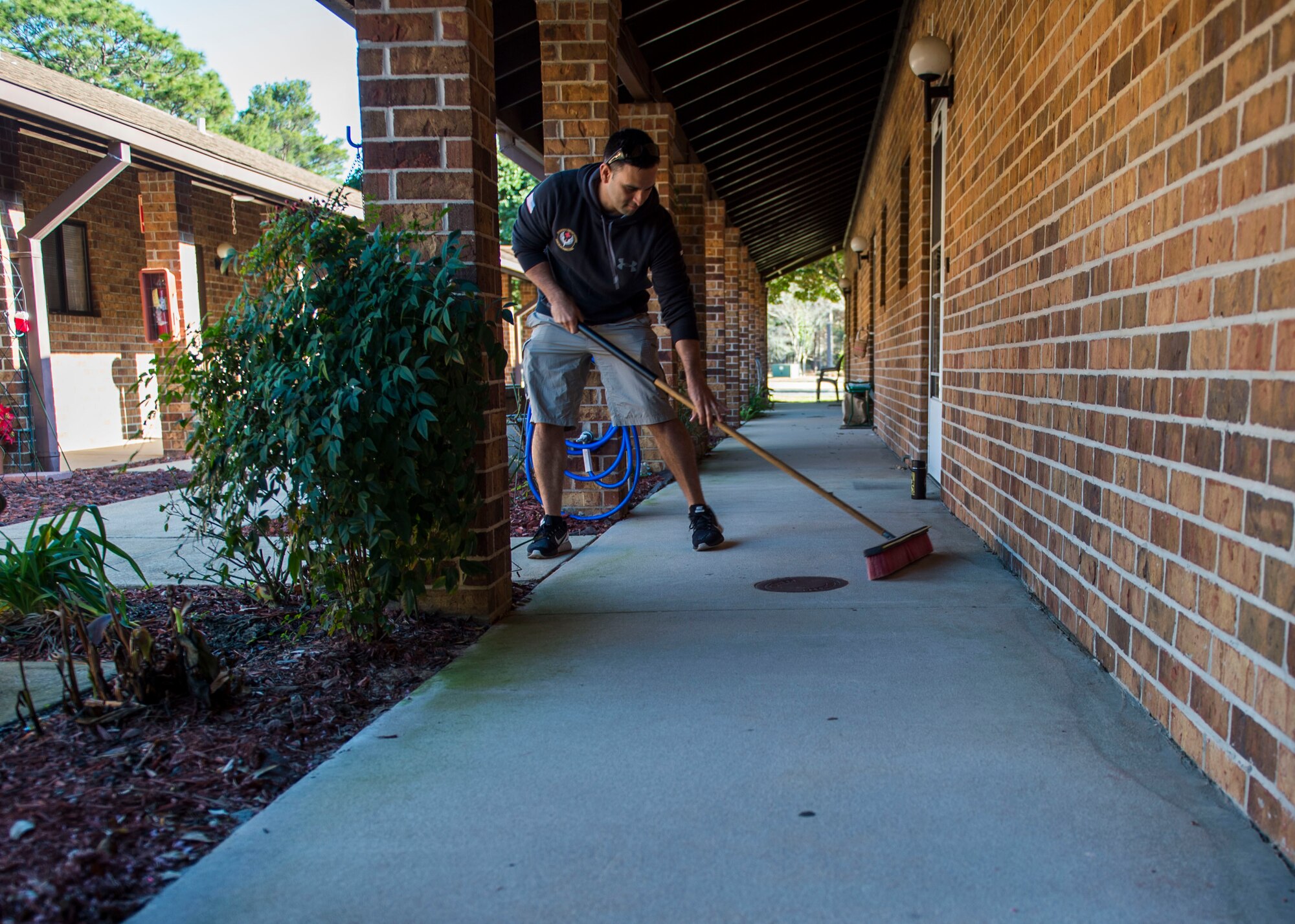 Tech. Sgt. Jose Rodriguez, an independent duty medical technician with the 1st Special Operations Support Squadron, sweeps a walk way for a resident at the Bob Hope Village in Shalimar, Fla., Feb. 2, 2017. Airmen from the 4th Special Operations Squadron and the 1st Special Operations Support Squadron spent the morning helping residents with minor tasks around their homes and yards. (U.S. Air Force photo by Senior Airman Krystal M. Garrett)