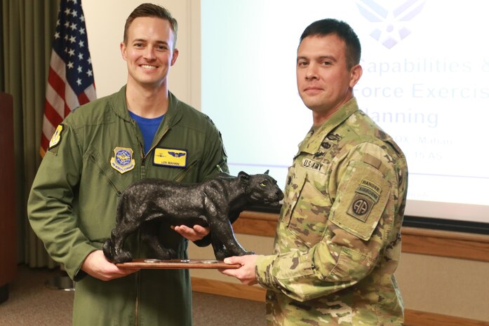 Lt. Col. Marcus Wright, commander of 1st Battalion, 505th Parachute Infantry Regiment, 3rd Brigade Combat Team, 82nd Airborne Division and Capt. Chris Mahan, assigned to the 437th Airlift Wing gather for a picture after a leadership development briefing at Joint-Base Charleston, S.C., Feb. 3, 2017. The 1-505 present the AW with a regimental Panther gift as a token of gratitude for senior leadership development at the base. (U.S. Army photo by Sgt. Anthony Hewitt)
