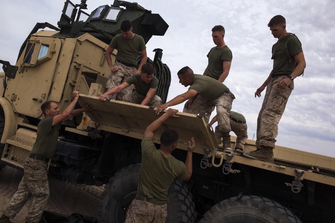 U.S. Marines with 8th Engineer Support Battalion reassemble the bed of a vehicle as part of a squad competition at Cannon Air Defense Complex, Yuma, Ariz., Oct. 24, 2016. Squad competitions happen among every unit throughout the Marine Corps to build camaraderie and Esprit de Corps. (U.S. Marine Corps photo taken by Lance Cpl. Christian Cachola/Released)