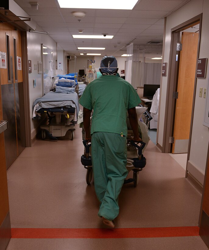 U.S. Army Private 1st Class Kwadwo Adapong, McDonald Army Health Center operating room technician, brings a patient back to prepare for surgery at Joint Base Langley-Eustis, Va., Jan. 31, 2017. Surgical services at MCAHC features a two-room surgical suite to support seven specialties. (U.S. Air Force photo by Staff Sgt. Teresa J. Cleveland)