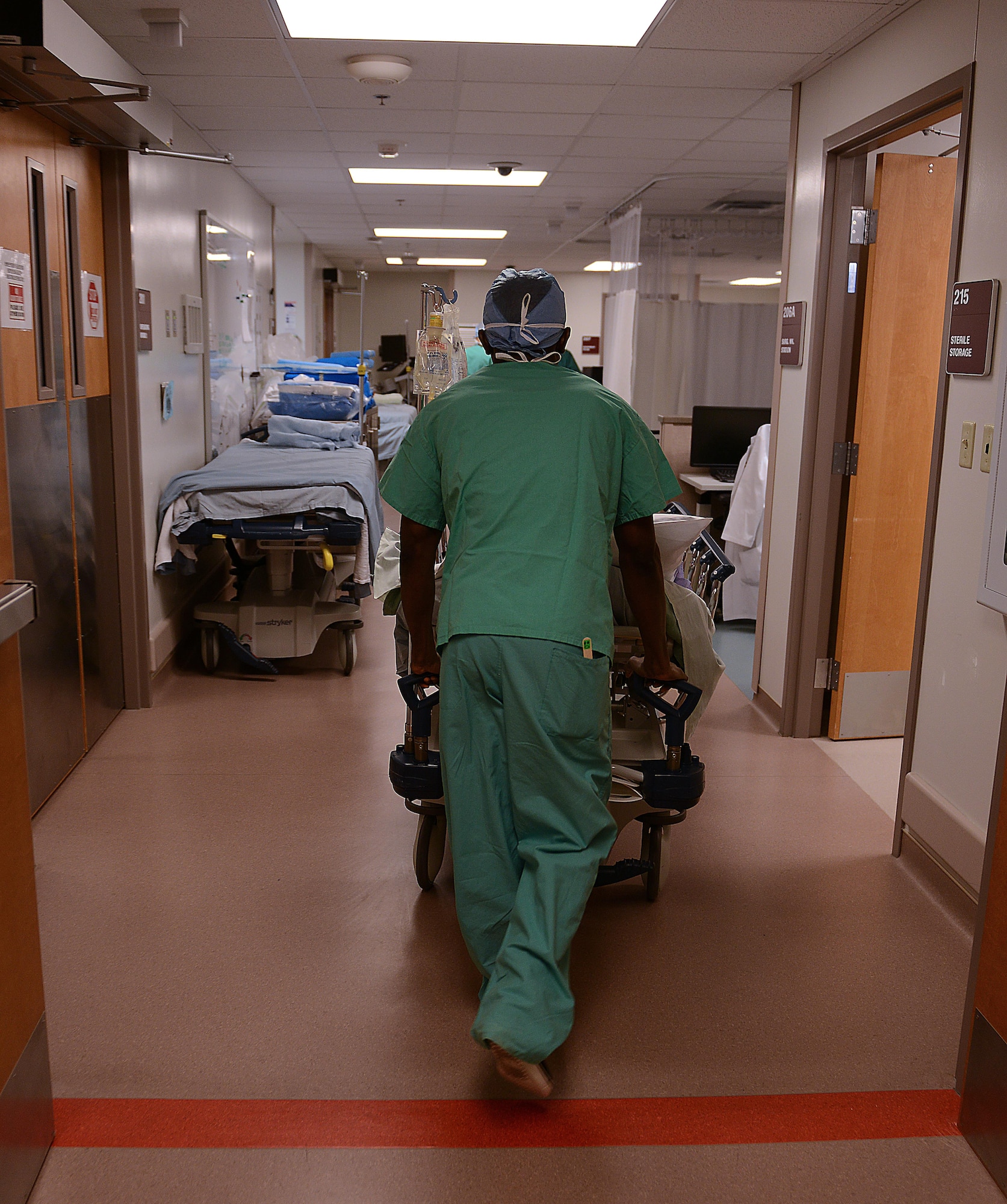 U.S. Army Private 1st Class Kwadwo Adapong, McDonald Army Health Center operating room technician, brings a patient back to prepare for surgery at Joint Base Langley-Eustis, Va., Jan. 31, 2017. Surgical services at MCAHC features a two-room surgical suite to support seven specialties. (U.S. Air Force photo by Staff Sgt. Teresa J. Cleveland)