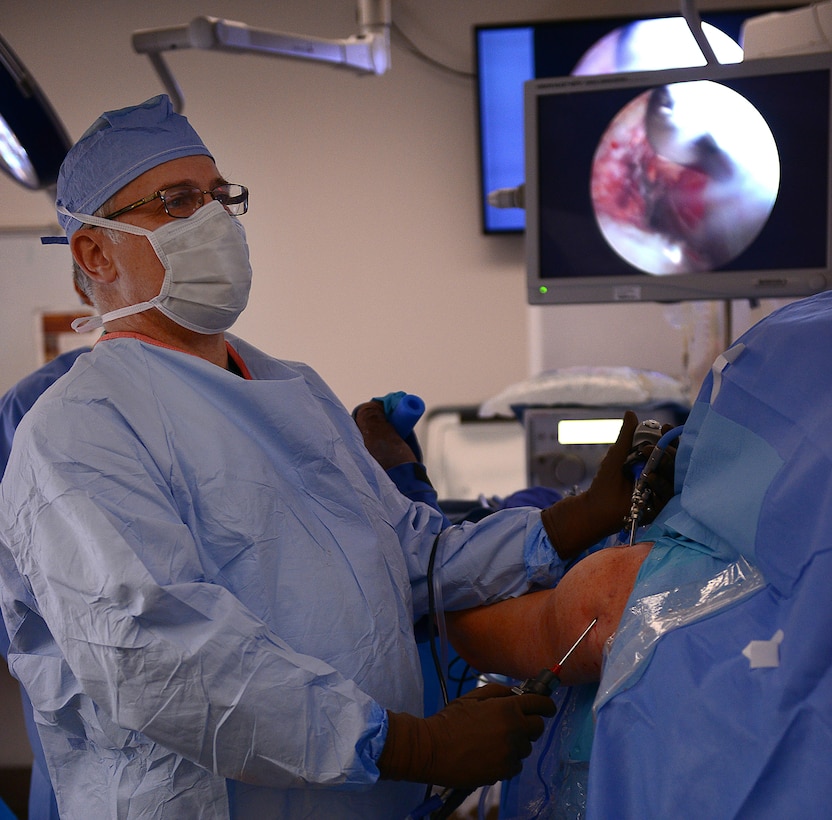 Harry Warren, McDonald Army Health Center orthopedic surgeon, looks at monitors displaying the camera view inside a patient’s shoulder during a procedure at Joint Base Langley-Eustis, Va., Jan. 31, 2017. Each specialty clinic performs surgeries on specific days to allow for easily transitioned preparation each week. (U.S. Air Force photo by Staff Sgt. Teresa J. Cleveland)