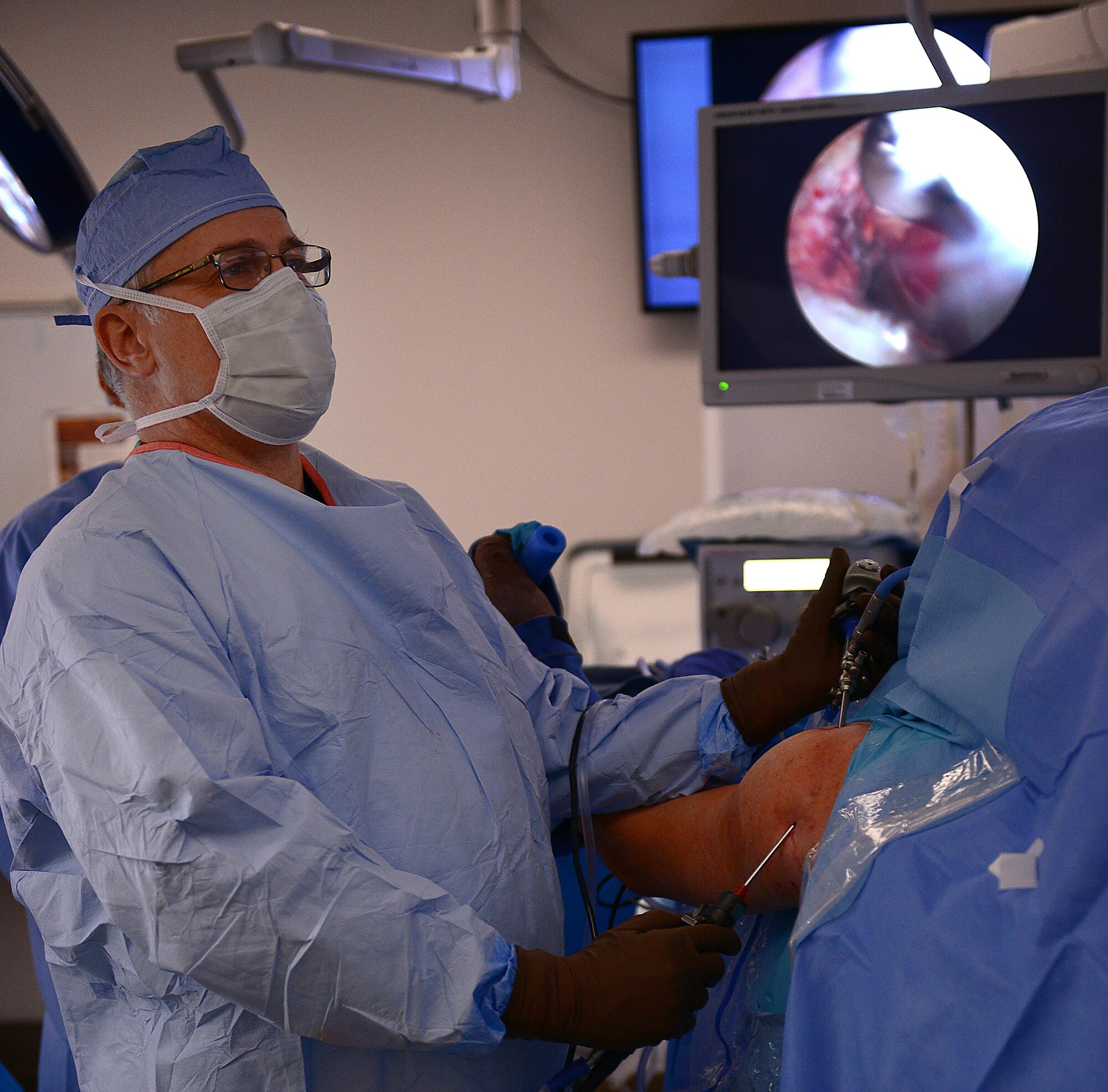 Harry Warren, McDonald Army Health Center orthopedic surgeon, looks at monitors displaying the camera view inside a patient’s shoulder during a procedure at Joint Base Langley-Eustis, Va., Jan. 31, 2017. Each specialty clinic performs surgeries on specific days to allow for easily transitioned preparation each week. (U.S. Air Force photo by Staff Sgt. Teresa J. Cleveland)