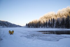 U.S. Air Force firefighters, assigned to the 673rd Civil Engineer Squadron, make their way over a frozen lake while conducting ice water rescue training at Joint Base Elmendorf-Richardson, Alaska Feb. 4, 2017. The training taught the JBER firefighters self-rescue techniques, victim recovery, and certified them as ice water rescue technicians. (U.S. Air Force photo/Alejandro Pena)