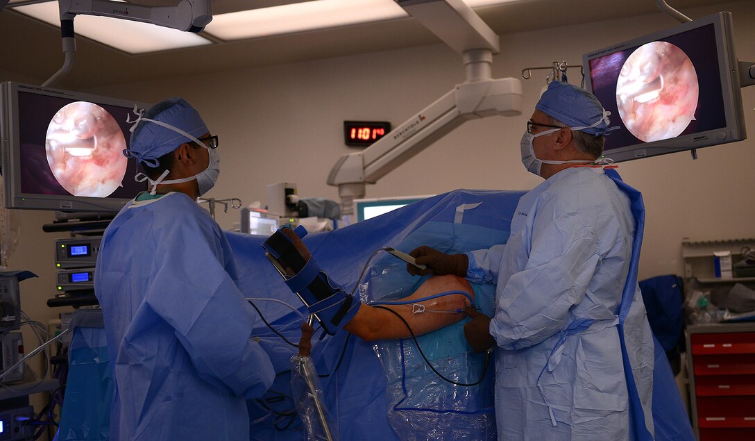 U.S. Army Private 1st Class Robert Garza, McDonald Army Health Center operating room technician, assists Harry Warren, MCAHC orthopedic surgeon, during a procedure at Joint Base Langley-Eustis, Va., Jan. 31, 2017. During procedures, surgeons are assisted by nurses and technicians from the same day surgery section as well as their specialty clinic. (U.S. Air Force photo by Staff Sgt. Teresa J. Cleveland)