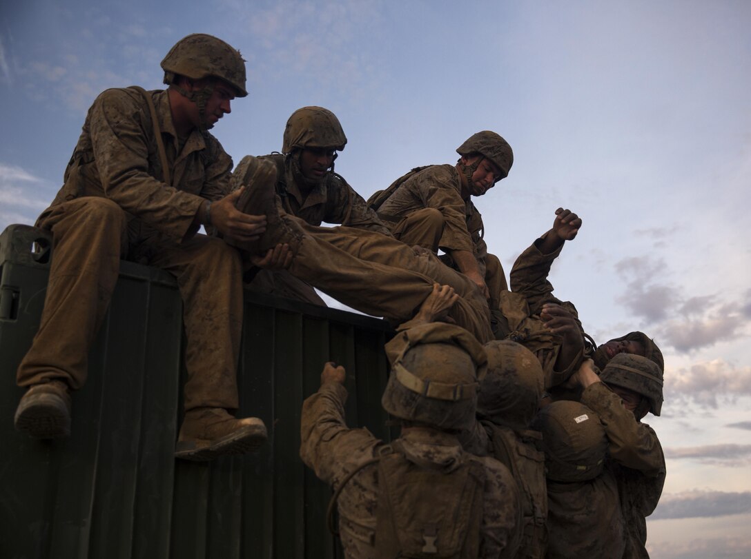 U.S. Marines with 8th Engineer Support Battalion work as a team to move a simulated casualty, down from a container as part of a squad competition at Cannon Air Defense Complex, Yuma, Ariz., Oct. 24, 2016. Squad competitions happen among every unit throughout the Marine Corps to build camaraderie and Esprit de Corps. (U.S. Marine Corps photo taken by Lance Cpl. Christian Cachola/Released)