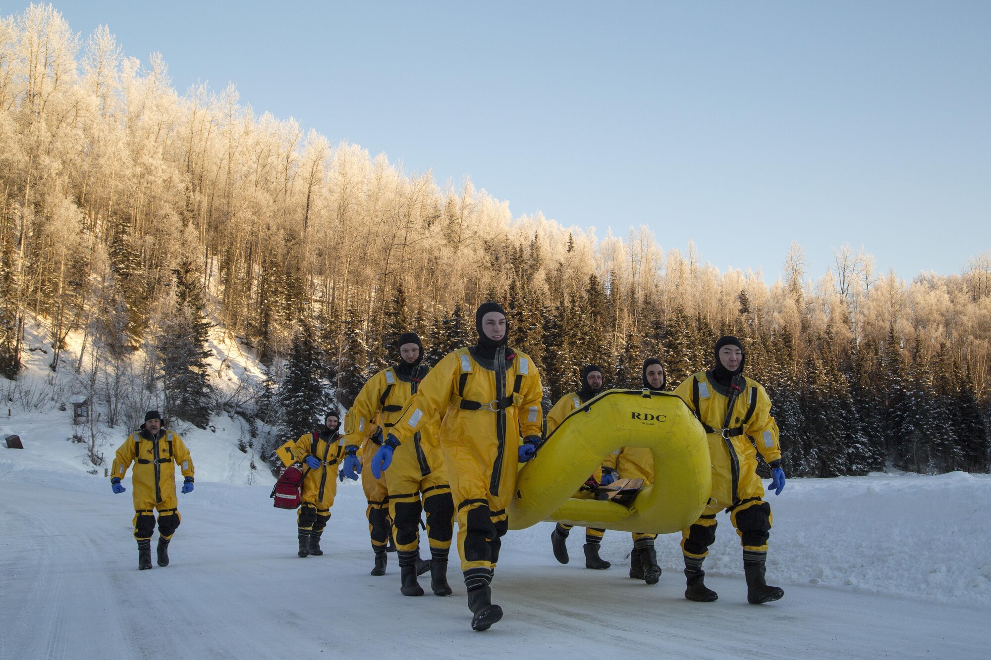 U.S. Air Force firefighters, assigned to the 673rd Civil Engineer Squadron, make their way to a frozen lake while conducting ice water rescue training at Joint Base Elmendorf-Richardson, Alaska Feb. 4, 2017. The training taught the JBER firefighters self-rescue techniques, victim recovery, and certified them as ice water rescue technicians. (U.S. Air Force photo/Alejandro Pena)