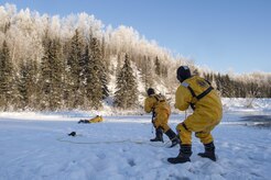 U.S. Air Force fire protection specialists, assigned to the 673rd Civil Engineer Squadron, practice recovering a simulated cold water victim while conducting ice water rescue training at Joint Base Elmendorf-Richardson, Alaska Feb. 4, 2017. The training taught the JBER firefighters self-rescue techniques, victim recovery, and certified them as ice water rescue technicians. (U.S. Air Force photo/Alejandro Pena)