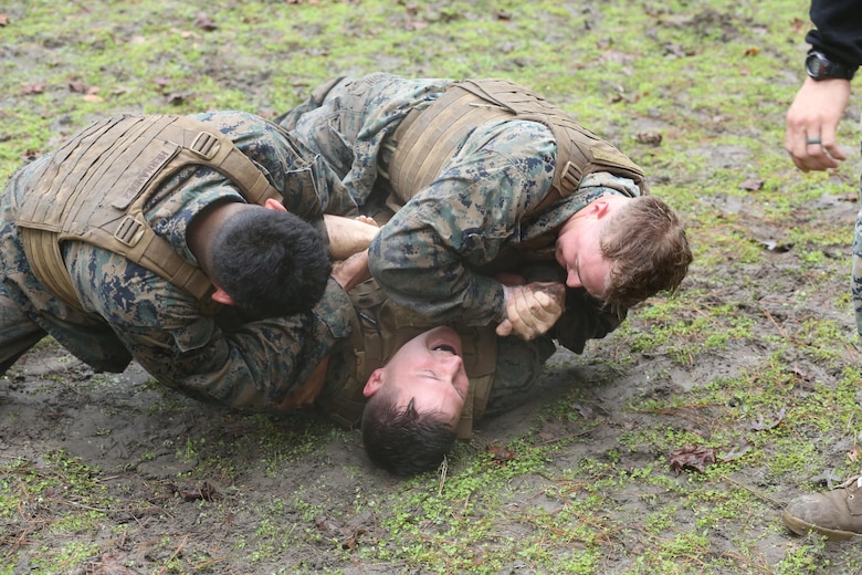 Cpl. Austin Richards grapples with Sgt. Abel Hernandez and Cpl. Austin Hardin during the culminating event of the Martial Arts Instructor course aboard Marine Corps Air Station Cherry Point, N.C., Feb. 3, 2017. The course included various mentally and physically demanding events such as; hikes, ground fighting and weapons training. The three-week course teaches the Marines the skills necessary to properly instruct the Marine Corps Martial Arts Program to fellow Marines. Richards is a flight equipment technician assigned to Marine Medium Tiltrotor Squadron 261, Marine Aircraft Group 26, 2nd Marine Aircraft Wing. Hernandez is a field radio operator assigned to 2nd Low Altitude Air Defense Battalion, Marine Air Control Group 28, 2nd MAW. (U.S. Marine Corps photo by Lance Cpl. Cody Lemons/Released)