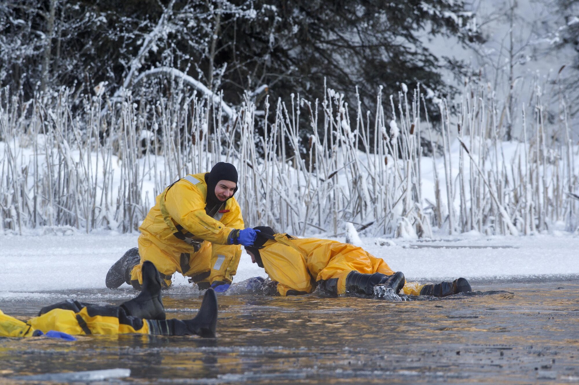 U.S. Air Force fire protection specialists Airmen 1st Class Tyler Parmelee, left, and Joseph Humphrey, practice victim recovery while conducting ice water rescue training at Joint Base Elmendorf-Richardson, Alaska Feb. 4, 2017. The training taught the JBER firefighters self-rescue techniques, victim recovery, and certified them as ice water rescue technicians. Parmelee and Humphrey, natives of Ashburn, Va., and Ridgecrest, Calif., respectively, are assigned to the 673rd Civil Engineer Squadron. (U.S. Air Force photo/Alejandro Pena)