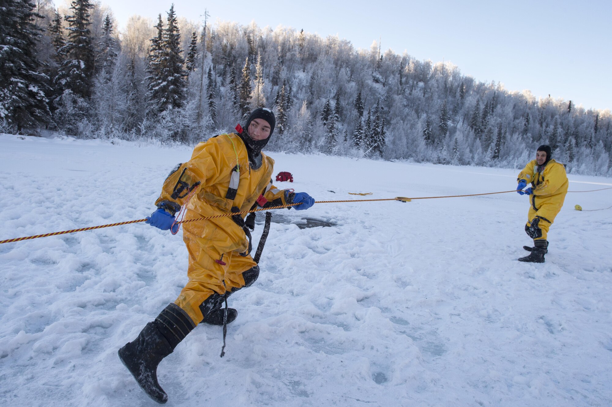 U.S. Air Force fire protection specialists Airmen 1st Class Joseph Humphrey, left and Tyler Parmelee recover a simulated victim while conducting ice water rescue training at Joint Base Elmendorf-Richardson, Alaska Feb. 4, 2017. The training taught the JBER firefighters self-rescue techniques, victim recovery, and certified them as ice water rescue technicians. Humphrey and Parmelee, natives of Ridgecrest, Calif., and Ashburn, Va., respectively, are assigned to the 673rd Civil Engineer Squadron. (U.S. Air Force photo/Alejandro Pena)
