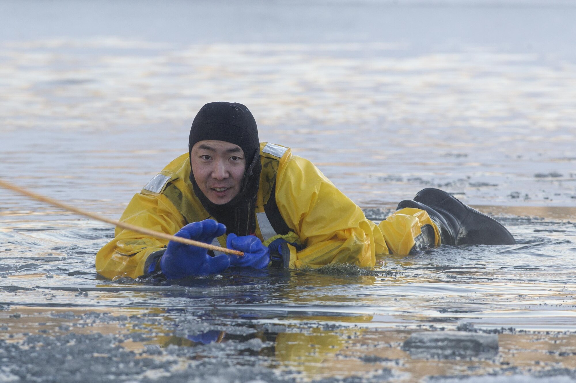 U.S. Air Force Senior Airman Joseph Pyun, a fire protection specialist assigned to the 673rd Civil Engineer Squadron, conducts ice water rescue training at Joint Base Elmendorf-Richardson, Alaska Feb. 4, 2017. The training taught the JBER firefighters self-rescue techniques, victim recovery, and certified them as ice water rescue technicians. Pyun is a native of Cypress, Calif. (U.S. Air Force photo/Alejandro Pena)