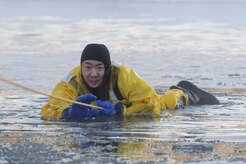 U.S. Air Force Senior Airman Joseph Pyun, a fire protection specialist assigned to the 673rd Civil Engineer Squadron, conducts ice water rescue training at Joint Base Elmendorf-Richardson, Alaska Feb. 4, 2017. The training taught the JBER firefighters self-rescue techniques, victim recovery, and certified them as ice water rescue technicians. Pyun is a native of Cypress, Calif. (U.S. Air Force photo/Alejandro Pena)