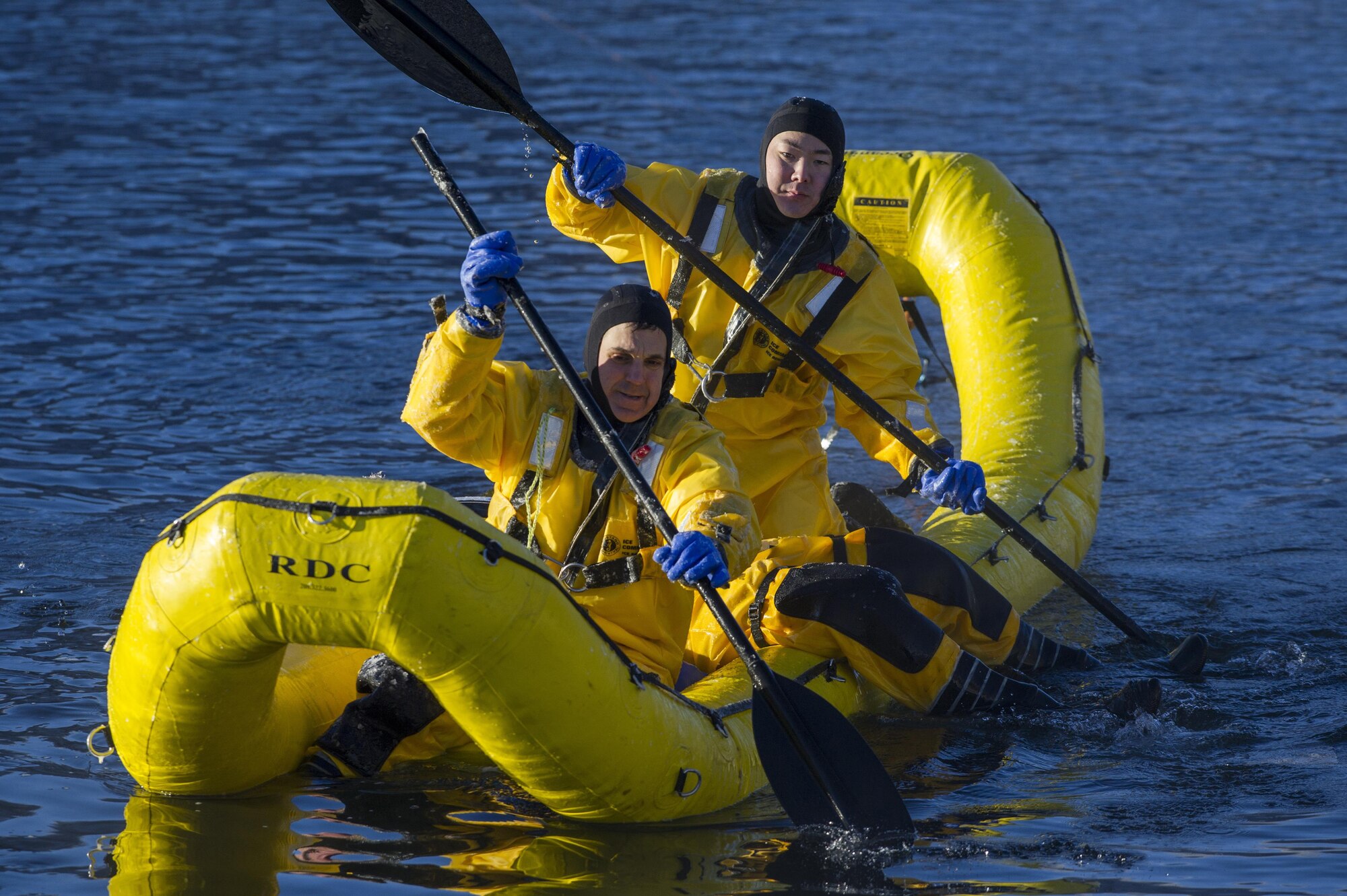 U.S. Air Force fire protection specialists, assigned to the 673rd Civil Engineer Squadron, use an inflatable raft to recover a simulated cold water victim while conducting ice water rescue training at Joint Base Elmendorf-Richardson, Alaska Feb. 4, 2017. The training taught the JBER firefighters self-rescue techniques, victim recovery, and certified them as ice water rescue technicians. (U.S. Air Force photo/Alejandro Pena)