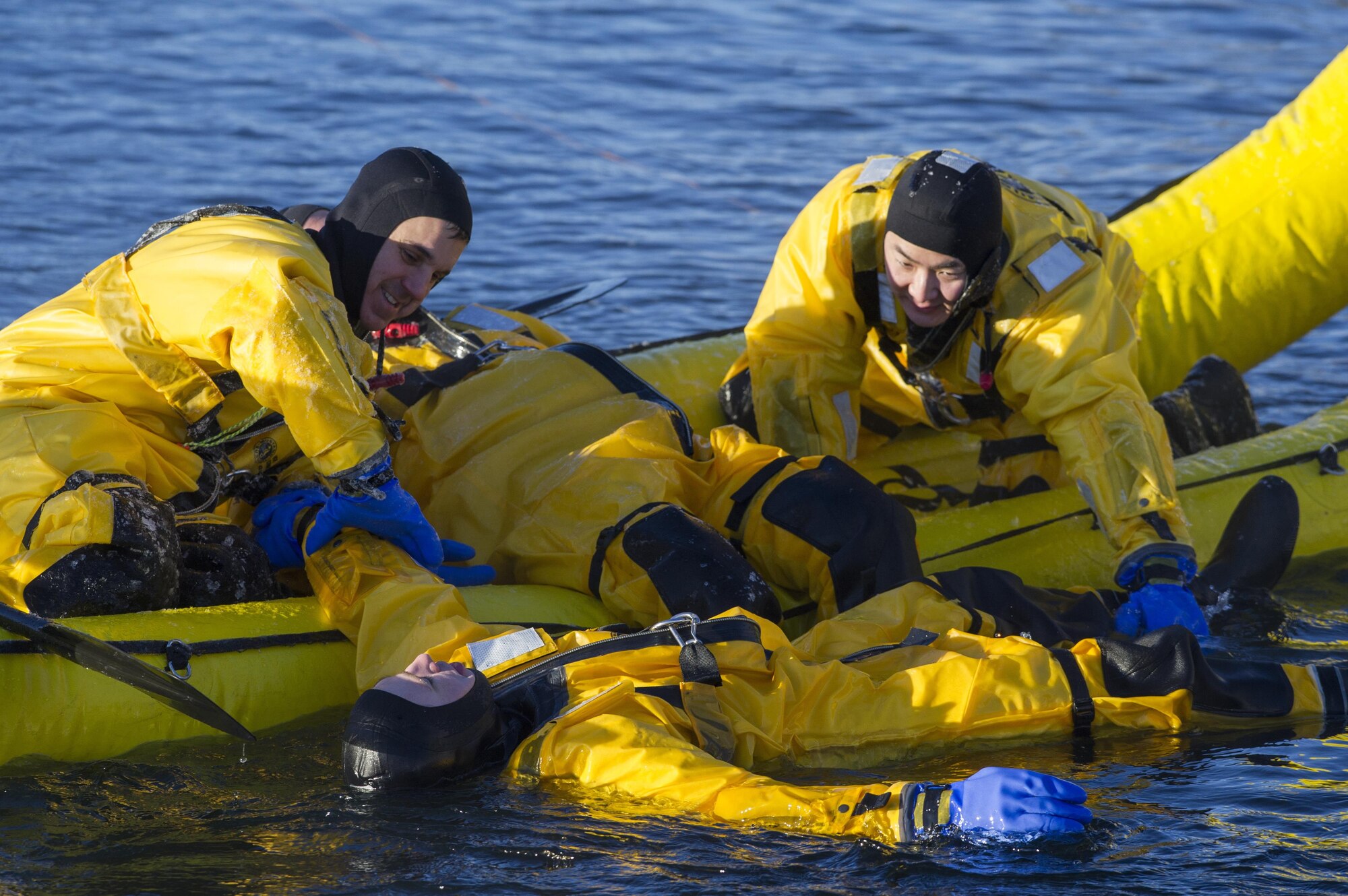 Jason Crandall, left and Senior Airman Joseph Pyun, firefighters assigned to the 673rd Civil Engineer Squadron, recover a simulated cold water victim while conducting ice water rescue training at Joint Base Elmendorf-Richardson, Alaska Feb. 4, 2017. The training taught the JBER firefighters self-rescue techniques, victim recovery, and certified them as ice water rescue technicians. (U.S. Air Force photo/Alejandro Pena)