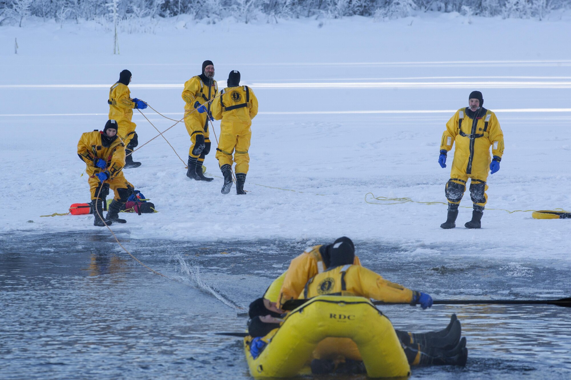 U.S. Air Force fire protection specialists, assigned to the 673rd Civil Engineer Squadron, conduct ice water rescue training at Joint Base Elmendorf-Richardson, Alaska Feb. 4, 2017. The training taught the JBER firefighters self-rescue techniques, victim recovery, and certified them as ice water rescue technicians. (U.S. Air Force photo/Alejandro Pena)