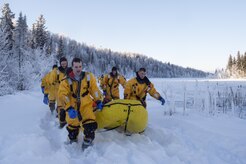 U.S. Air Force firefighters, assigned to the 673rd Civil Engineer Squadron, leave a frozen lake after conducting ice water rescue training at Joint Base Elmendorf-Richardson, Alaska Feb. 4, 2017. The training taught the JBER firefighters self-rescue techniques, victim recovery, and certified them as ice water rescue technicians. (U.S. Air Force photo/Alejandro Pena)