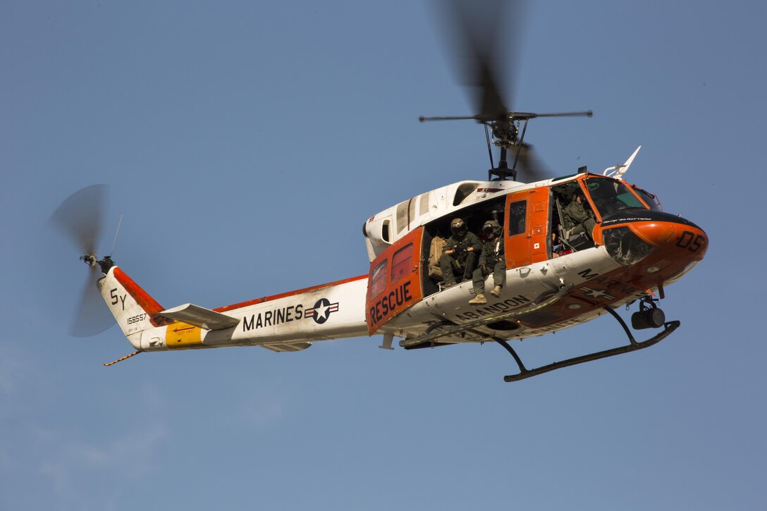 An HH-1N “Huey” flies overhead to deliver a ceremonial sword during the annual cake cutting ceremony at Marine Corps Air Station Yuma, Ariz., Nov. 10, 2016. The delivery of the sword by a U.S. Navy Corpsman to a U.S. Marine signifies the bond between the Navy and Marine Corps. (U.S. Marine Corps photo by Lance Cpl. Christian Cachola/Released)