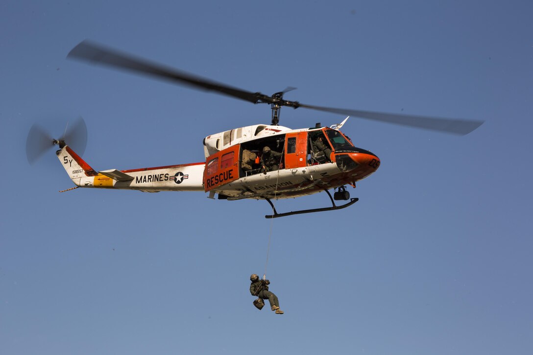 An HH-1N “Huey” flies overhead to deliver a ceremonial sword during the annual cake cutting ceremony at Marine Corps Air Station Yuma, Ariz., Nov. 10, 2016. The delivery of the sword by a U.S. Navy Corpsman to a U.S. Marine signifies the bond between the Navy and Marine Corps. (U.S. Marine Corps photo by Lance Cpl. Christian Cachola/Released)