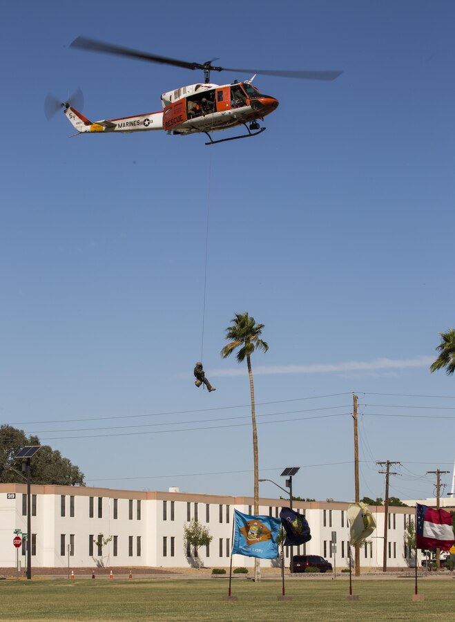 An HH-1N “Huey” flies overhead to deliver a ceremonial sword during the annual cake cutting ceremony at Marine Corps Air Station Yuma, Ariz., Nov. 10, 2016. The delivery of the sword by a U.S. Navy Corpsman to a U.S. Marine signifies the bond between the Navy and Marine Corps. (U.S. Marine Corps photo by Lance Cpl. Christian Cachola/Released)