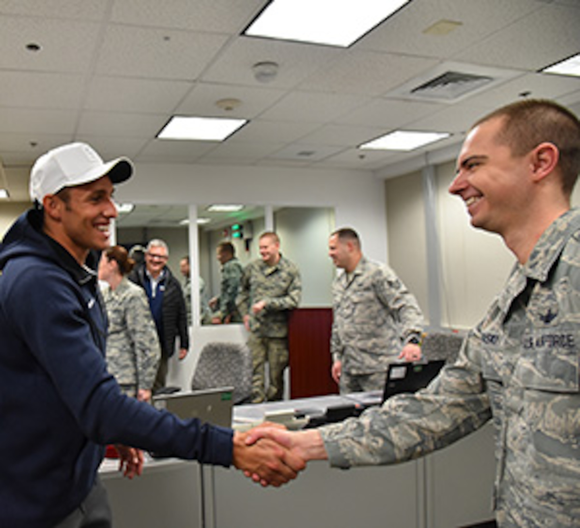 THULE AIR BASE, Greenland – Sam Dorman, 2016 Olympic silver medalist, greets members of the 821st Air Base Group at Thule Air Base, Greenland, Jan. 21, 2017. Dorman and Troy Dumais, four-time Olympian, visited the Top of the World as part of the “Dive Into Service” program. (Courtesy photo)