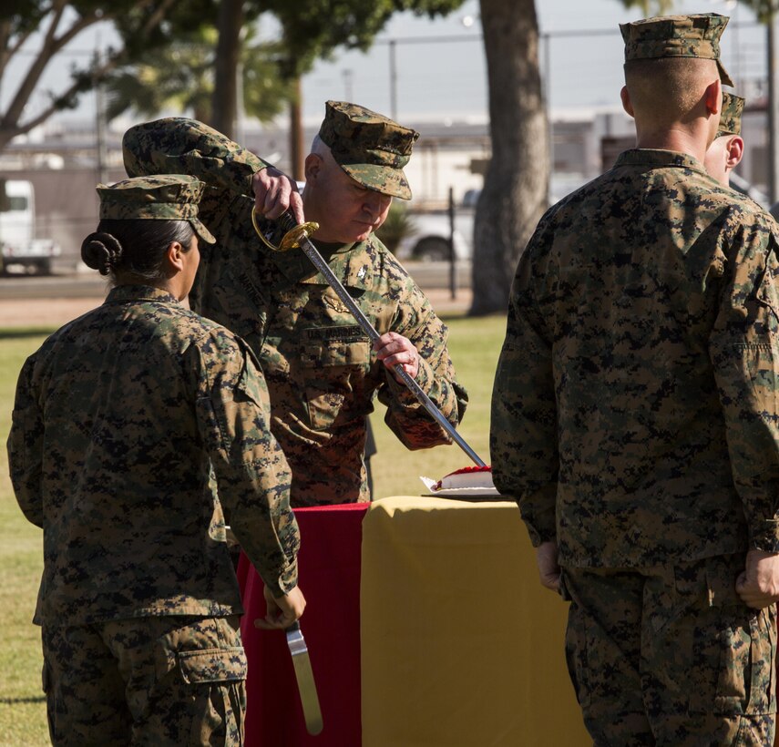 U.S. Marine Corps Col. Ricardo Martinez, the station commanding officer, slices into a birthday cake using a ceremonial sword during the annual cake cutting ceremony aboard Marine Corps Air Station Yuma, Ariz., Nov. 10, 2016. The uniform pageant and cake cutting ceremony are annual traditions held to celebrate the Marine Corps birthday, honor Marines of the past, present and future and signify the passing of traditions from one generation to the next. (U.S. Marine Corps photo by Lance Cpl. Christian Cachola/Released)