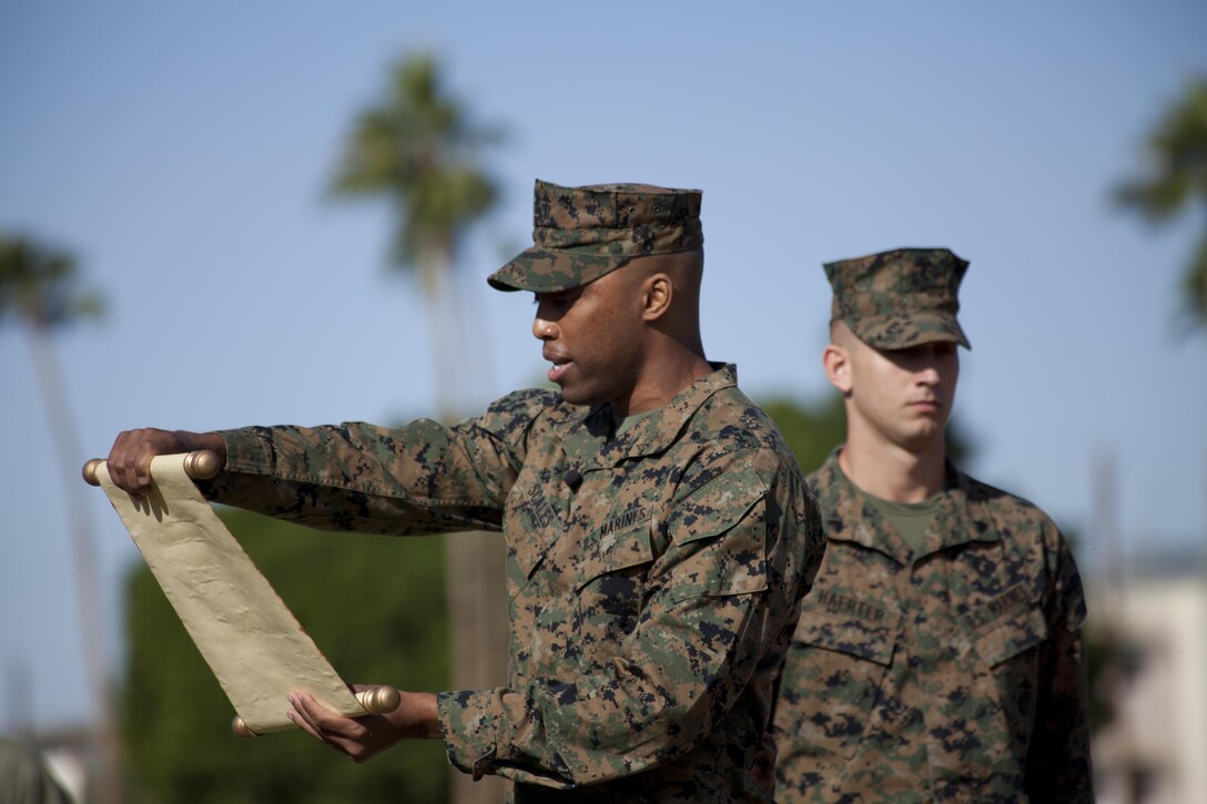 U.S. Marine Corps Lt. Daryl Scales, the Headquarters and Headquarters Squadron adjutant, reads the 13th Commandant's birthday message as part of the annual cake cutting ceremony at Marine Corps Air Station Yuma, Ariz., Nov. 10, 2016. The ceremony celebrates the 241st birthday of the Marine Corps, and serves to honor Marines of the past, present and future while signifying the passing of traditions from one generation to the next. (U.S. Marine Corps photo by Lance Cpl. Joel Soriano/Released)