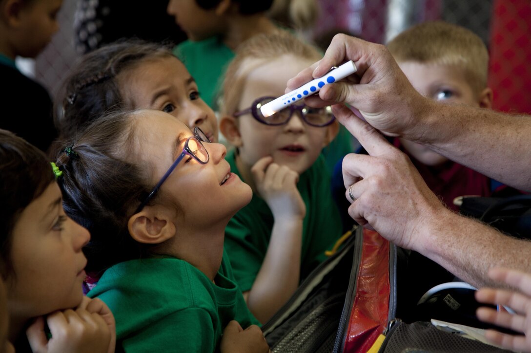Students with Gowan Science Academy interact with Aircraft Rescue and Firefighters at Marine Corps Air Station (MCAS) Yuma, Ariz., Nov. 21, 2016. MCAS Yuma conducted a tour with Gowan Science Academy in an effort to provide educational presentations for the community of Yuma. (U.S. Marine Corps photo taken by Lance Cpl. Joel Soriano/ Released)