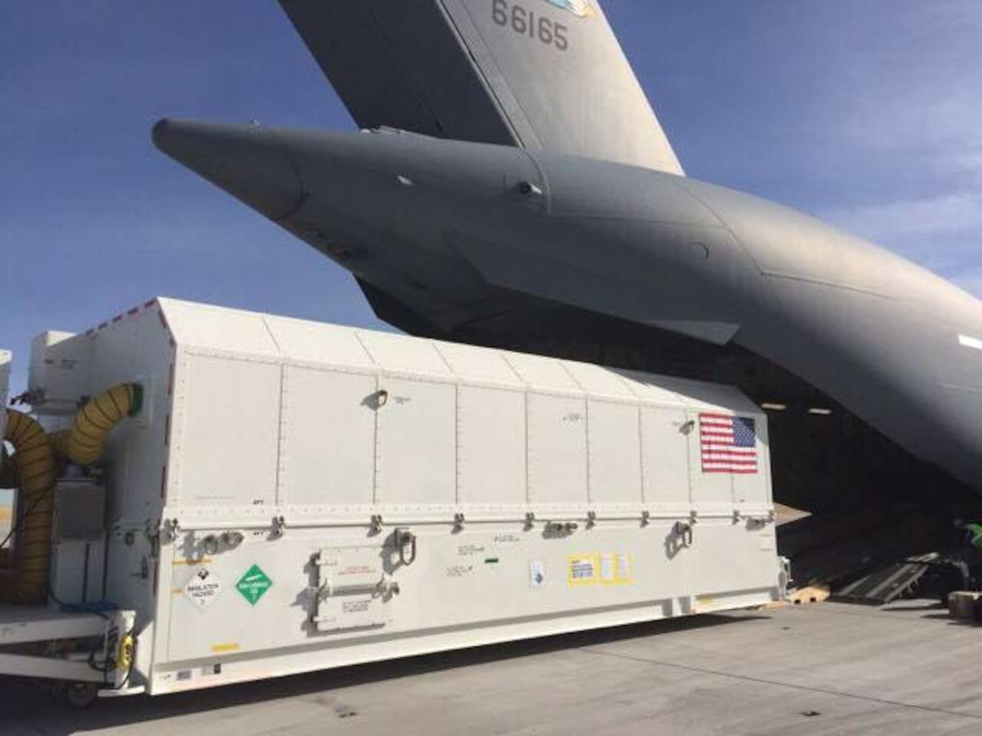 Personnel offload a shipping container, with a GPS Block IIIA Satellite Pathfinder inside, from a C-17 Globemaster III, operated by the 3d Airlift Squadron, Jan. 31, 2017, at Buckley Air Force Base, Colo. The GPS III Satellite Pathfinder was sent to Florida in December to validate the required transportation procedures needed to get a satellite to the launch facility. (Courtesy photo)