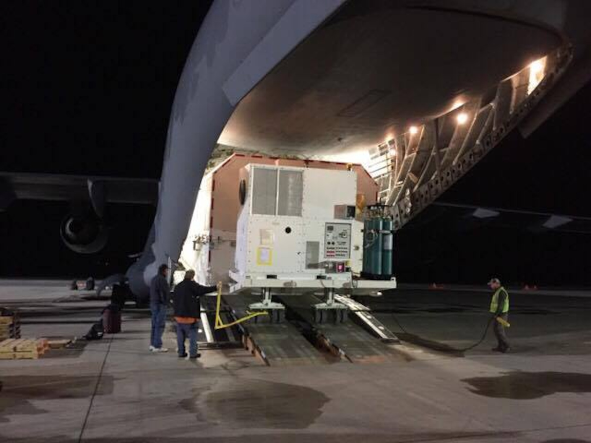 Personnel load a shipping container, with a GPS Block IIIA Satellite Pathfinder inside, onto a C-17 Globemaster III, operated by the 3d Airlift Squadron, Jan. 29, 2017, at Space Coast Regional Airport in Titusville, Fla. This was first time an active duty C-17 squadron loaded and moved this type of cargo. (Courtesy photo)