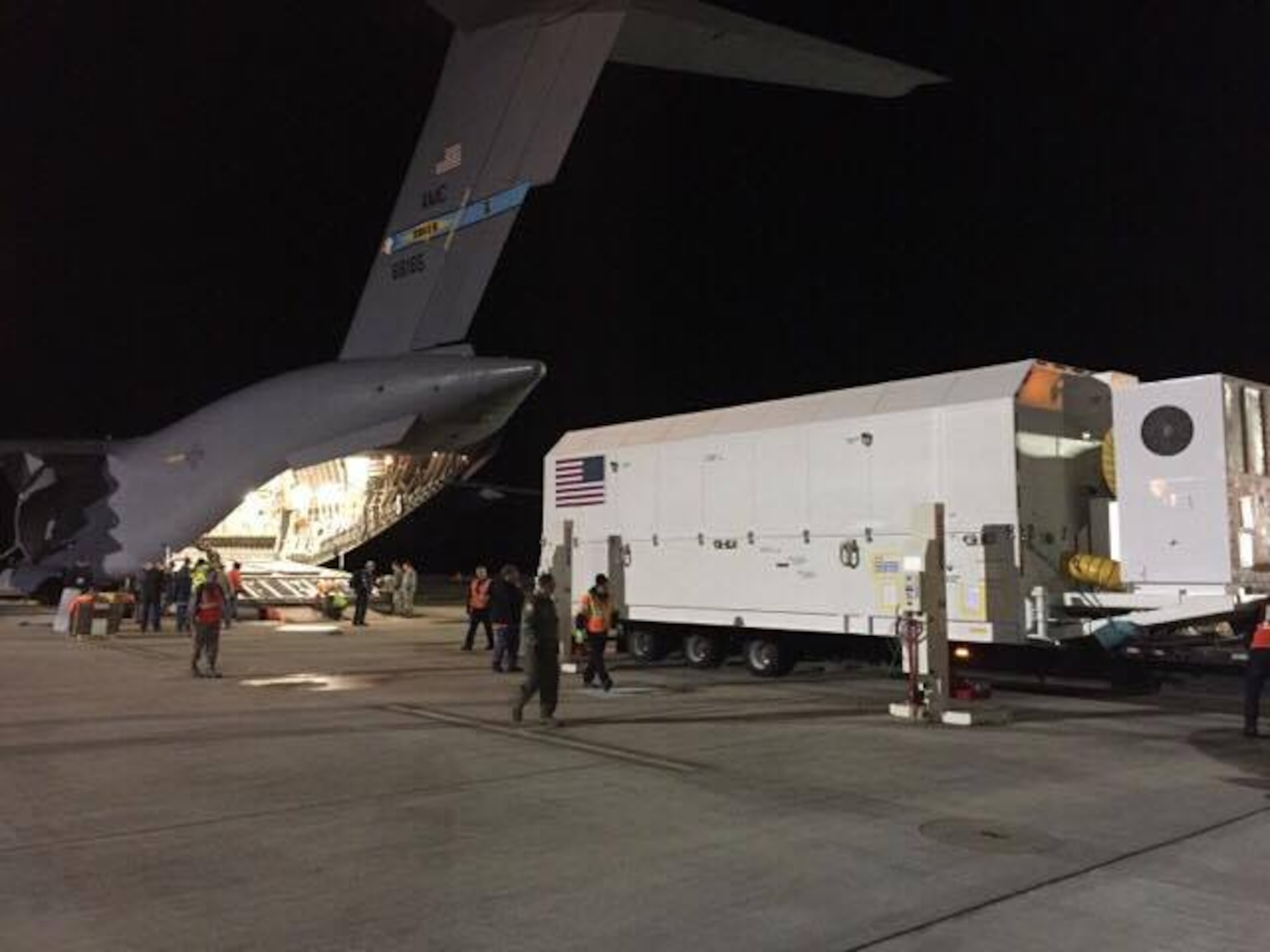 Personnel load a shipping container, with a GPS Block IIIA Satellite Pathfinder inside, onto a C-17 Globemaster III, operated by the 3d Airlift Squadron, Jan. 29, 2017, at Space Coast Regional Airport in Titusville, Fla. The load weighed in excess of 67,000 pounds. (Courtesy photo)
