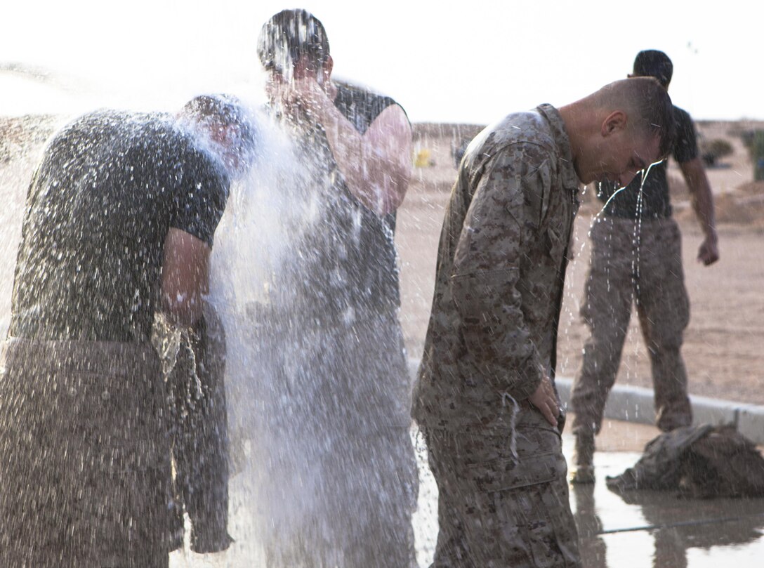 U.S. Marine Corps Cpl. Murray with 8th Engineer Support Battalion washes off with his squad after competing in a field meet at Canon Air Defense Complex, Yuma, Ariz., Oct. 24, 2016. Squad competitions happen among every squadron throughout the Marine Corps to build camaraderie and foster good-spirited competition between the separate elements that make up the unit. (U.S. Marine Corps photo taken by Cpl. Summer Romero/ Released)