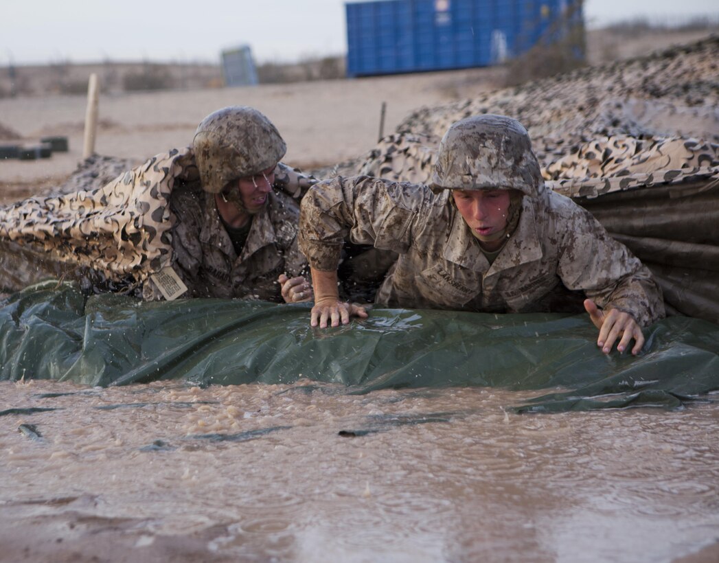 U.S. Marines with 8th Engineer Support Battalion low crawl through muddy water during a squad competition at Canon Air Defense Complex, Yuma, Ariz., Oct. 24, 2016. Squad competitions happen among every squadron throughout the Marine Corps to build camaraderie and foster good-spirited competition between the separate elements that make up the unit. (U.S. Marine Corps photo taken by Cpl. Summer Romero/ Released)