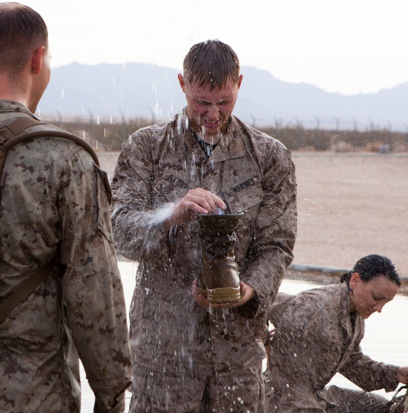 A U.S. Marine with 8th Engineer Support Battalion washes off with his squad after competing in a field meet at Canon Air Defense Complex, Yuma, Ariz., Oct. 24, 2016. Squad competitions happen among every squadron throughout the Marine Corps to build camaraderie and foster good-spirited competition between the separate elements that make up the unit. (U.S. Marine Corps photo taken by Cpl. Summer Romero/ Released)