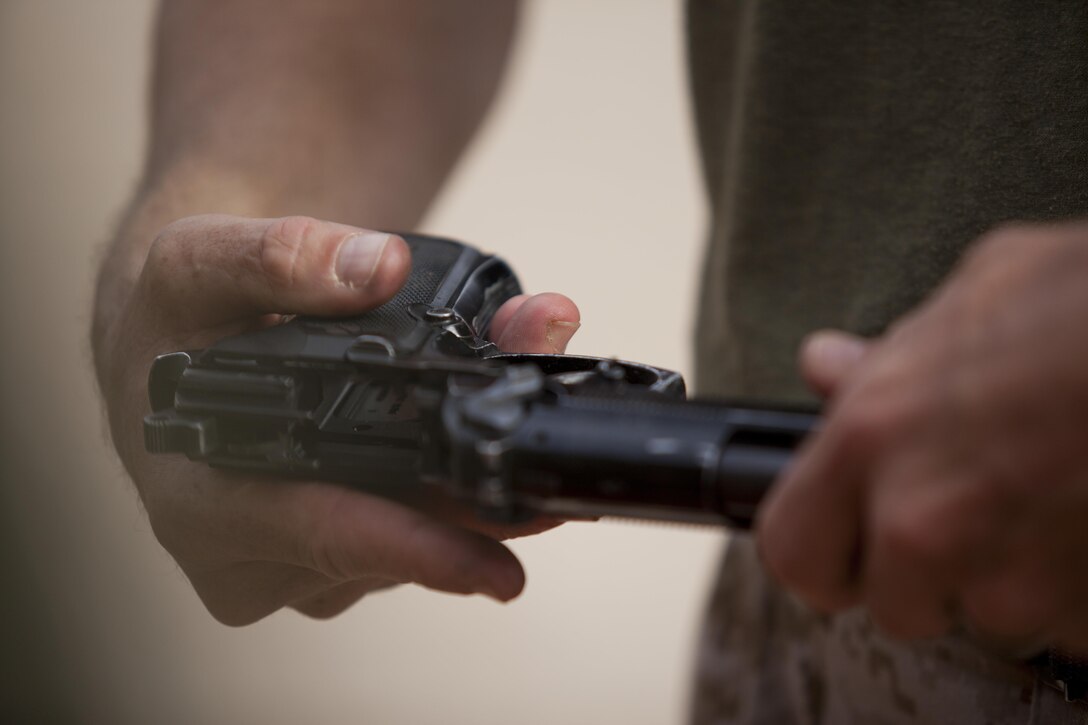 A U.S. Marine with 8th Engineer Support Battalion disassemles and assembles an M9 pistol as part of an exercise during a squad competition at Canon Air Defense Complex, Yuma, Ariz., Oct. 24, 2016. Squad competitions happen among every squadron throughout the Marine Corps to build camaraderie and foster good-spirited competition between the separate elements that make up the unit. (U.S. Marine Corps photo taken by Cpl. Summer Romero/ Released)