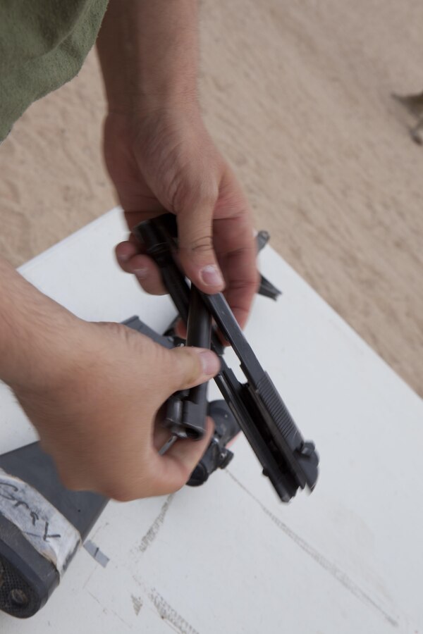 A U.S. Marine with 8th Engineer Support Battalion disassemles and assembles an M9 pistol as part of an exercise during a squad competition at Canon Air Defense Complex, Yuma, Ariz., Oct. 24, 2016. Squad competitions happen among every squadron throughout the Marine Corps to build camaraderie and foster good-spirited competition between the separate elements that make up the unit. (U.S. Marine Corps photo taken by Cpl. Summer Romero/ Released)