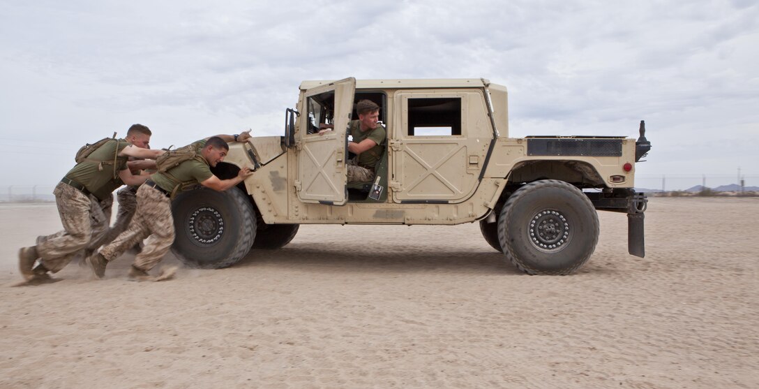 U.S. Marines with 8th Engineer Support Battalion push a humvee forward and in reverse during a squad competition at Canon Air Defense Complex, Yuma, Ariz., Oct. 24, 2016. Squad competitions happen among every squadron throughout the Marine Corps to build camaraderie and foster good-spirited competition between the separate elements that make up the unit. (U.S. Marine Corps photo taken by Cpl. Summer Romero/ Released)
