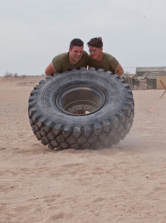 U.S. Marines with 8th Engineer Support Battalion pair up to flip tires during a squad competition at Canon Air Defense Complex, Yuma, Ariz., Oct. 24, 2016. Squad competitions happen among every squadron throughout the Marine Corps to build camaraderie and foster good-spirited competition between the separate elements that make up the unit. (U.S. Marine Corps photo taken by Cpl. Summer Romero/ Released)