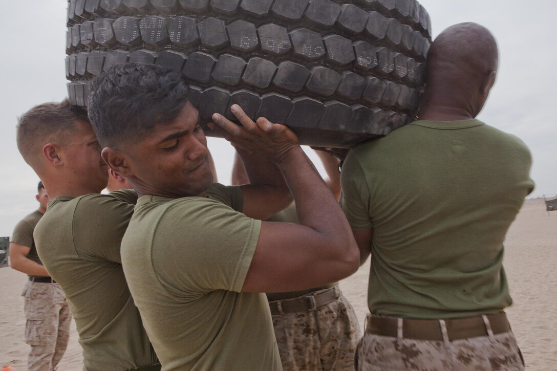 U.S. Marines with 8th Engineer Support Battalion conduct tire should presses during a squad competition at Canon Air Defense Complex, Yuma, Ariz., Oct. 24, 2016. Squad competitions happen among every squadron throughout the Marine Corps to build camaraderie and foster good-spirited competition between the separate elements that make up the unit. (U.S. Marine Corps photo taken by Cpl. Summer Romero/ Released)