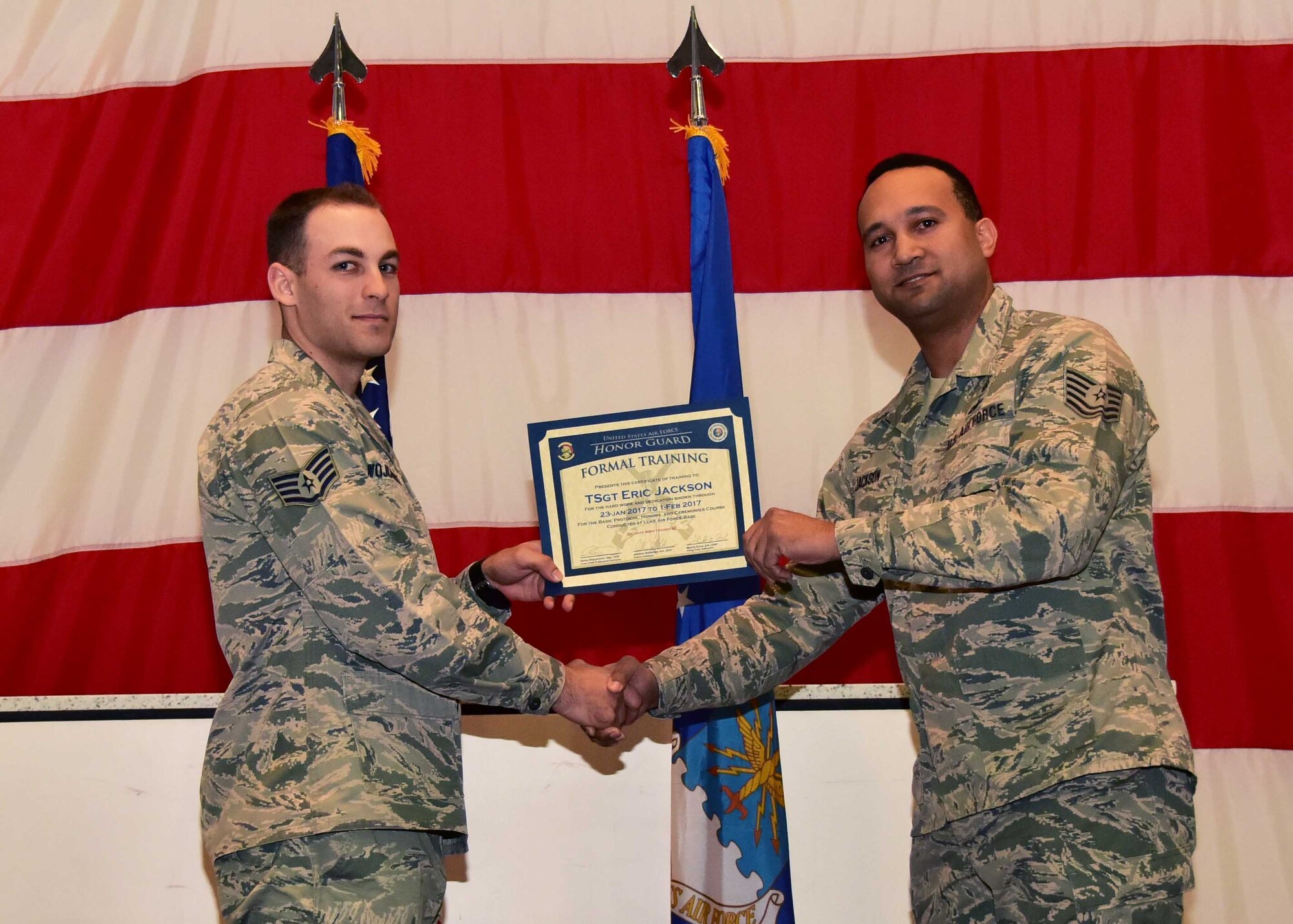 Tech. Sgt. Eric Jackson, 944th Medical Squadron optometry technician and Basic Protocol, Honors, and Ceremonies course graduate, receives a certificate from Staff Sgt. Steven Wojichowski, NCO-in-charge of the Ceremonial Training Unit, Feb. 1 during the graduation at Luke Air Force Base, Ariz. Jackson was one of two Airmen from the 944th Fighter Wing to complete the course on this day. (U.S. Air Force photo by Tech. Sgt. Louis Vega Jr.)
