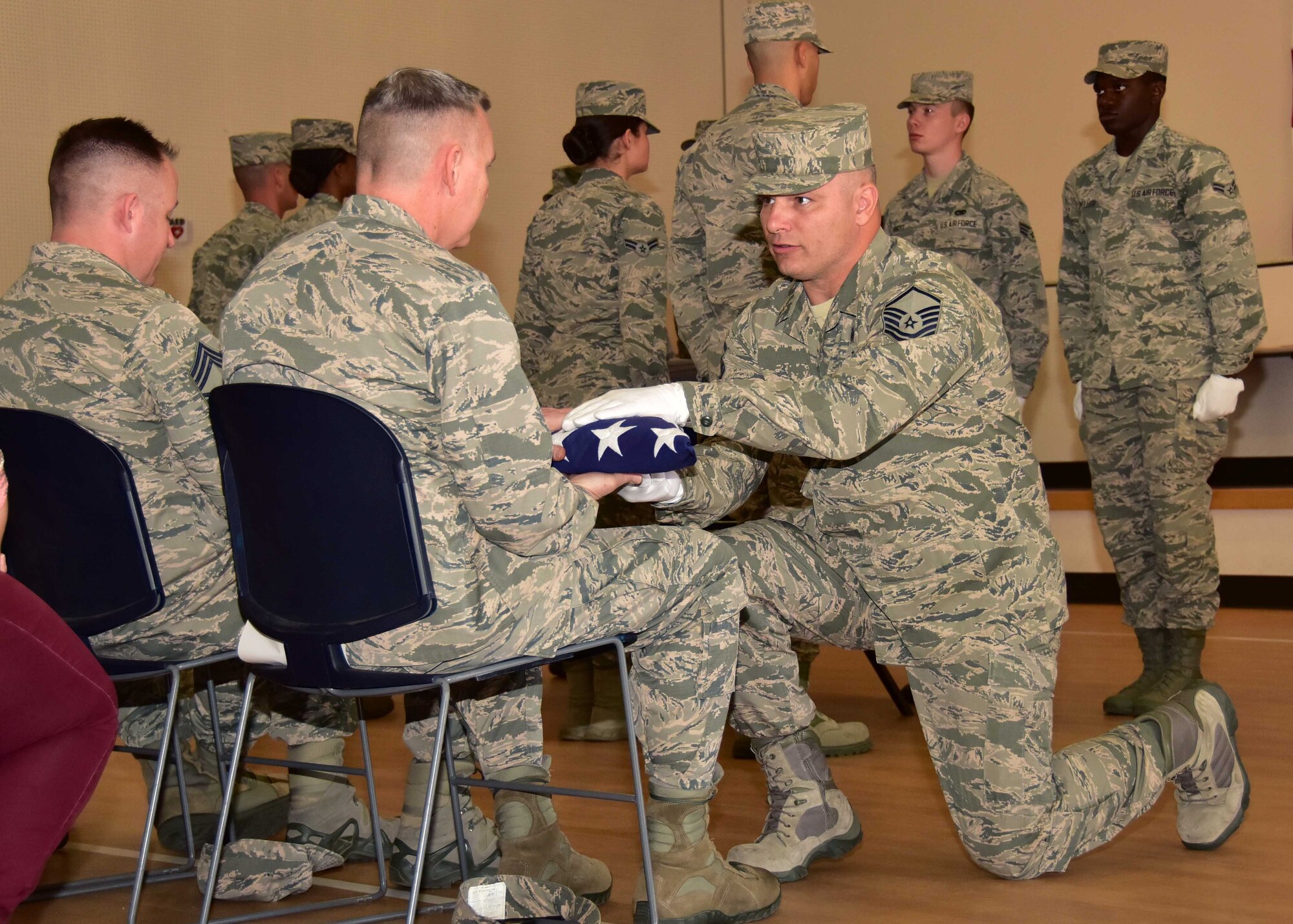 Master Sgt. Kenneth Heng, 944th Medical Squadron medical technician and Basic Protocol, Honors, and Ceremonies course class leader and graduate, presents a flag as part of a military funeral service performance Feb. 1 during his graduation from the course at Luke Air Force Base, Ariz. Heng was one of two Airmen from the 944th Fighter Wing to complete the course on this day. (U.S. Air Force photo by Tech. Sgt. Louis Vega Jr.)