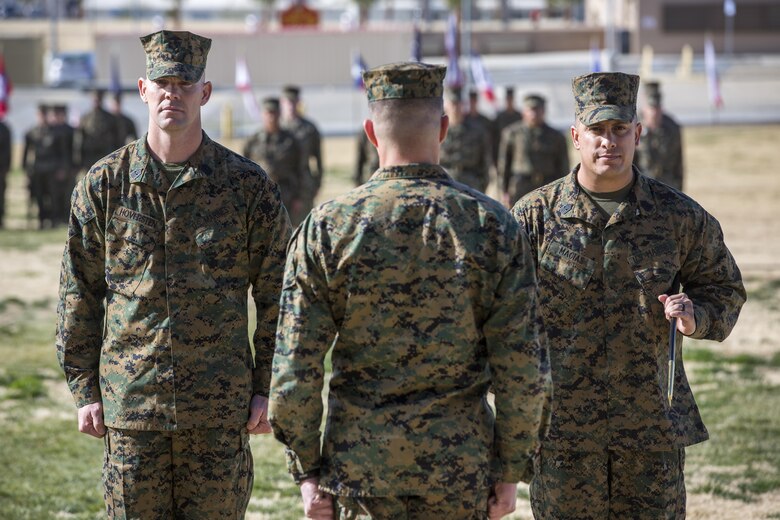 Sgt. Maj. Jared A. Hoversten, left, and Sgt. Maj. Gabriel E. Macias perform the traditional passing of the noncommissioned officer sword during a relief and appointment ceremony at Lance Cpl. Torrey L. Gray Field, Feb. 3, 2017. During the ceremony, Macias relinquished his post as battalion sergeant major for 2nd Battalion, 7th Marine Regiment, to Hoversten. (U.S. Marine Corps photo by Cpl. Levi Schultz)