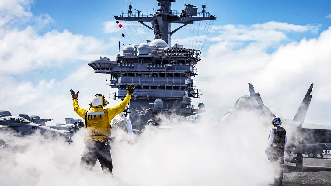 A sailor uses hand signals while conducting flight operations on the flight deck aboard the aircraft carrier USS Carl Vinson in the Pacific Ocean, Jan. 30, 2017. Navy photo by Petty Officer 2nd Class Sean M. Castellano