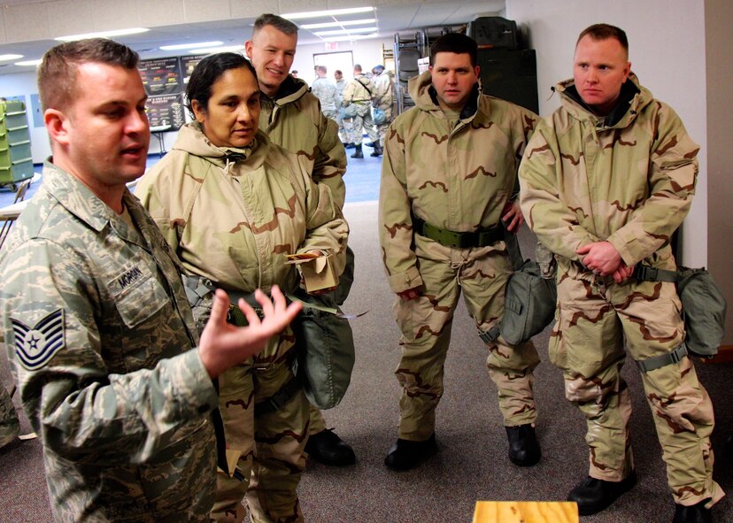 Tech. Sgt. Kevin Morgan, a civil engineering instructor, relays important information on understanding what to look for in a chemical attack situation to his eager "students" from left, Senior Master Sgt. Teresa Ray, Senior Master Sgt. Brian Rohlman, Maj. Christopher Kaighen, and Senior Master Sgt. Darren Wiseman.  They gathered for refresher training with other 932nd Airlift Wing members on February 7, 2017, Scott Air Force Base, Ill.  They spent many hours learning the proper way to carry and don their protective chemical environment suits.  (U.S. Air Force photo by Lt. Col. Stan Paregien)