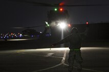 An Airman assigned to the 718th Aircraft Maintenance Squadron from Kadena Air Base, Japan, marshals an HH-60 Pave Hawk taking off for a combat search and rescue training mission at Osan Air Base, Republic of Korea, Feb. 2, 2017. The mission was part of Exercise Pacific Thunder, which is a Pacific Air Forces-wide exercise that provides rescue teams with a realistic scenario to practice CSAR missions in mountainous Korean terrain. (U.S. Air Force photo by Staff Sgt. Vic tor J. Caputo)