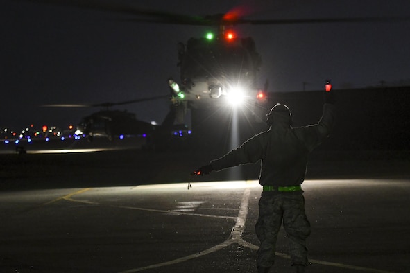 A U.S. Airman assigned to the 718th Aircraft Maintenance Squadron from Kadena Air Base, Japan, marshals an HH-60 Pave Hawk at Osan Air Base, Republic of Korea (ROK), Feb. 2, 2017. The mission was in support of Exercise Pacific Thunder, a regularly scheduled training event designed to enhance the readiness of U.S. and ROK forces to defend the Republic of Korea and sustain the capabilities which strengthen the ROK-U.S. Alliance.  (U.S. Air Force photo by Staff Sgt. Victor J. Caputo)