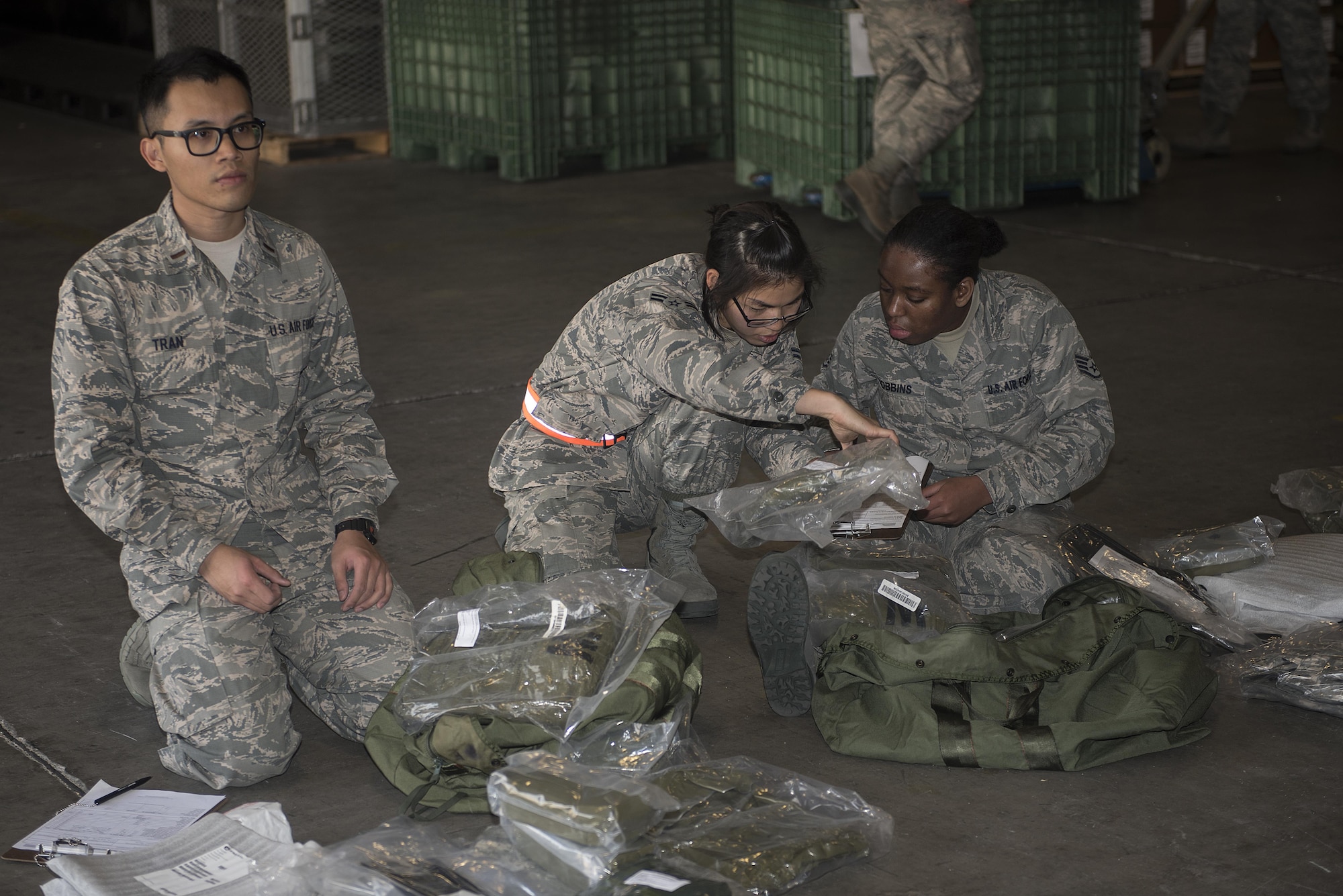 U.S. Air Force Airmen inventory their Mission-Oriented Protective Posture gear during an exercise Feb. 7, 2017, at Kadena Air Base, Japan. This is the first time Kadena has added issuing members’ real-world MOPP gear during a readiness exercise. (U.S. Air Force photo by Airman 1st Class Corey M. Pettis/Released)